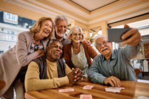 Group of residents taking picture together while gathered around table