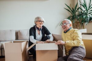 Smiling senior man and woman packing boxes for a move
