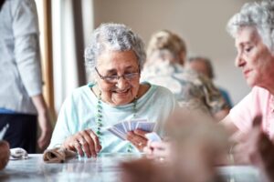 Senior women playing cards in an assisted living facility.
